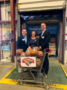 Photo of Jonathan Toms, Nicole Whalen and Brian Fabre with a carriage of Smithfield hams.