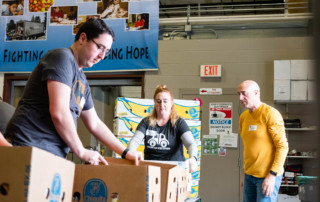 Photo of the Reed family at work at the Vermont Foodbank.
