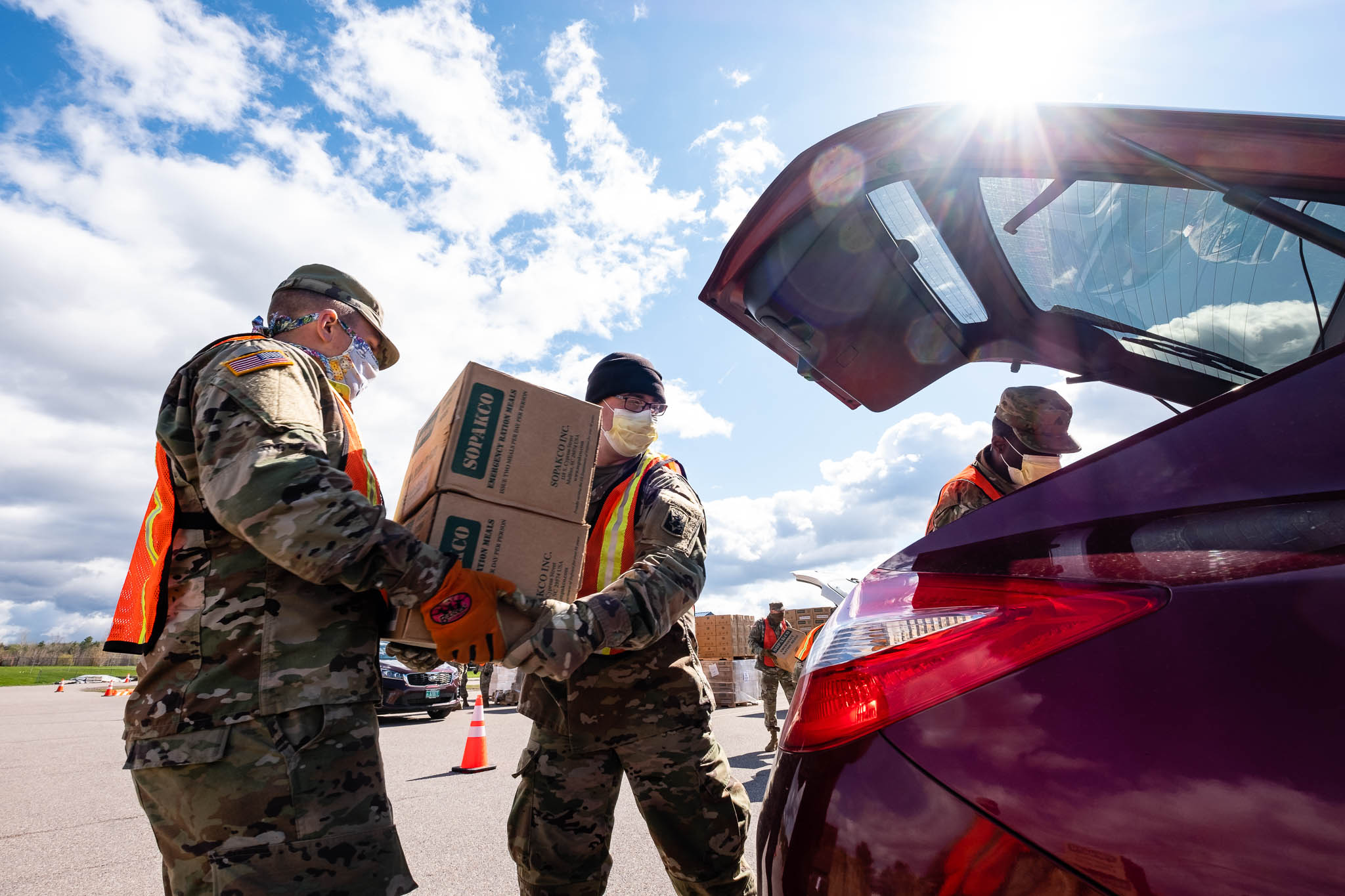 Photo of Vermont National Guard loading food into a car.