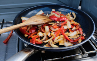 Photo of peppers and onions in a pan