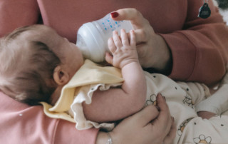 Photo of baby being bottle fed.